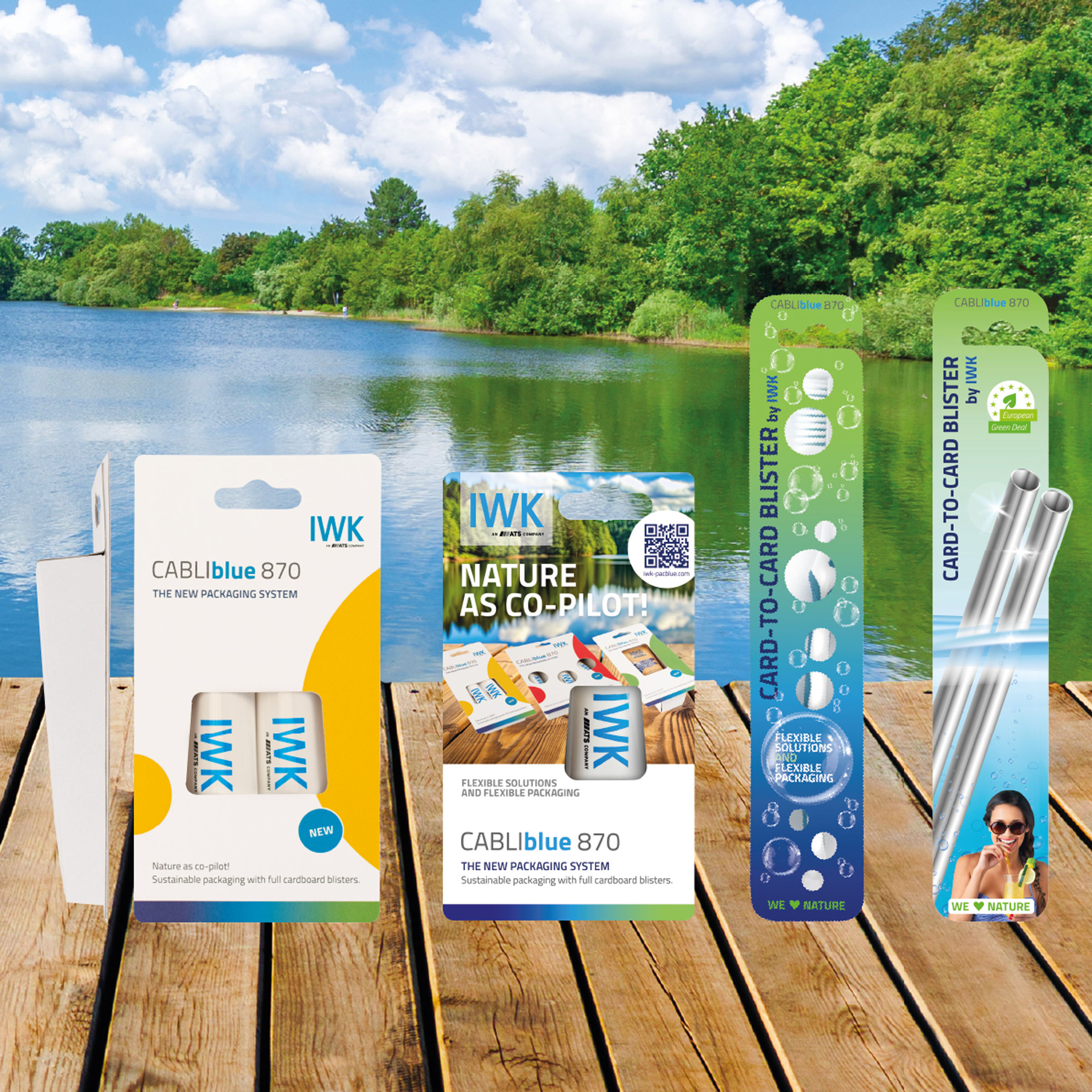Various IWK card-to-card packaging on a wooden walkway in front of a natural lake background.